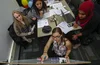 A group of young women collaborate on a project.