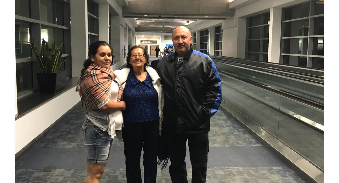 Orlando Jose Molina's parents stand in an airport hallway