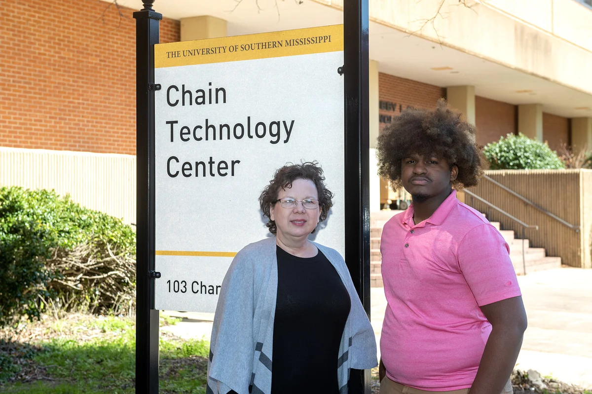 Dr. Sarah Lee, co-founder of Last Mile Education Fund stands with student Fredrick Jaynes, outside the University of Southern Mississippi’s Chain Technology Center.