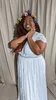 YouTube Creator Zenita AKA TruleyTalentedBeauty smiles in a white dress and flower crown