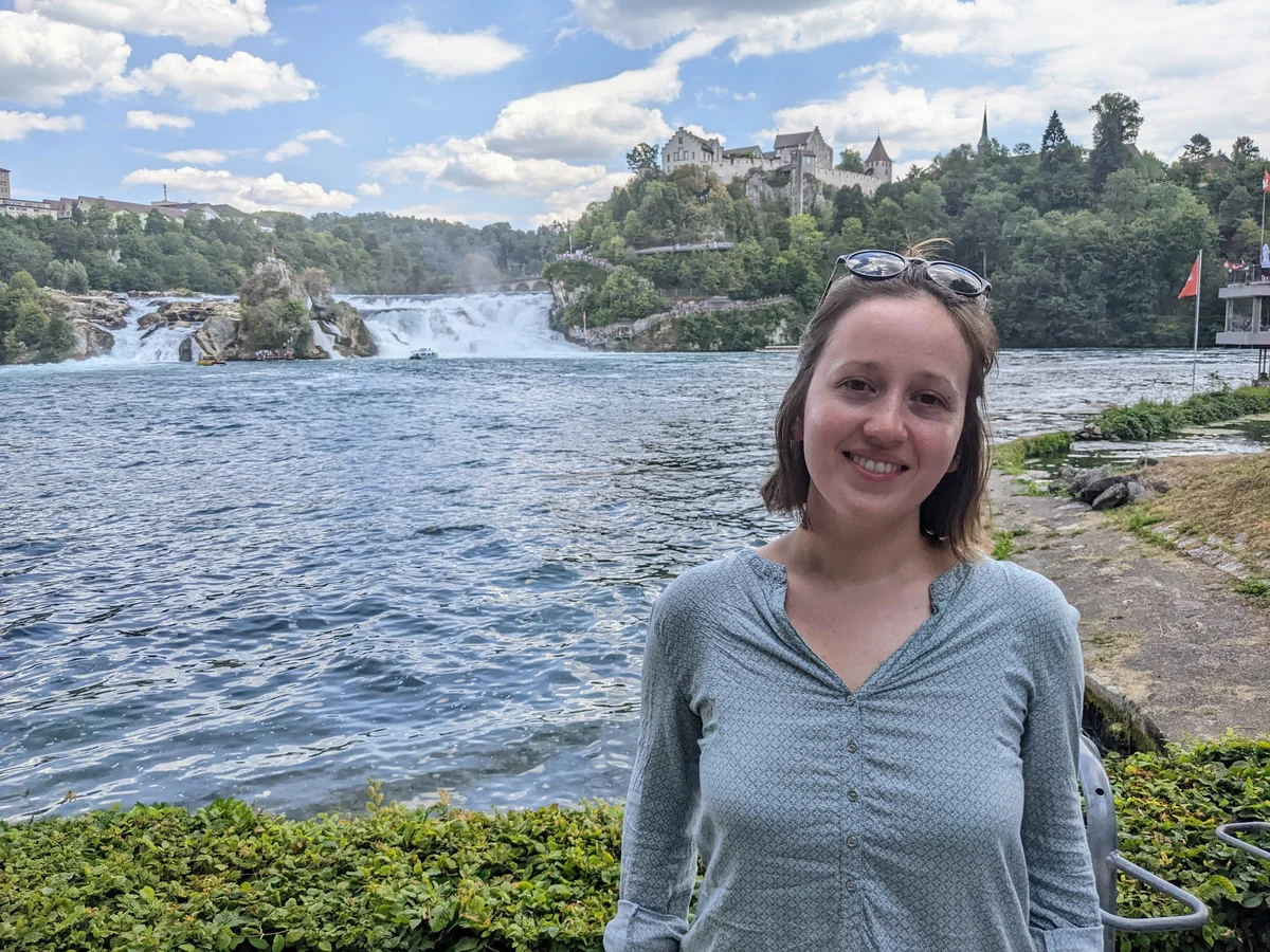 Article's hero media showing a young woman, Ana, at the Rhine Falls.