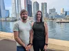 A photo of Researchers Dr Olaf Meynecke from Griffith University’s Whales and Climate Program and Dr Lauren Harrell from Google Research standing together in front of Sydney Harbour.