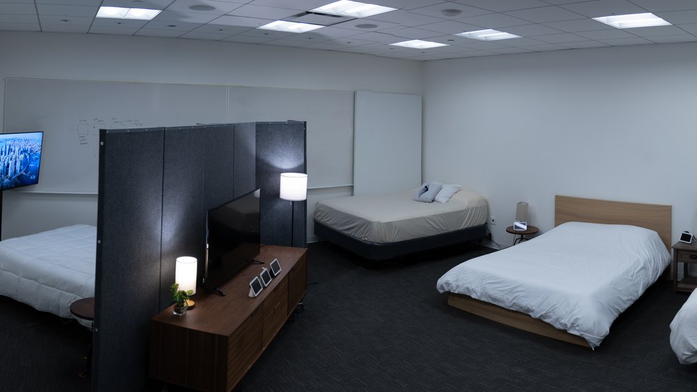 40 Winks, the sleep lab, with three beds and a bedside table set up with various Nest Hubs.