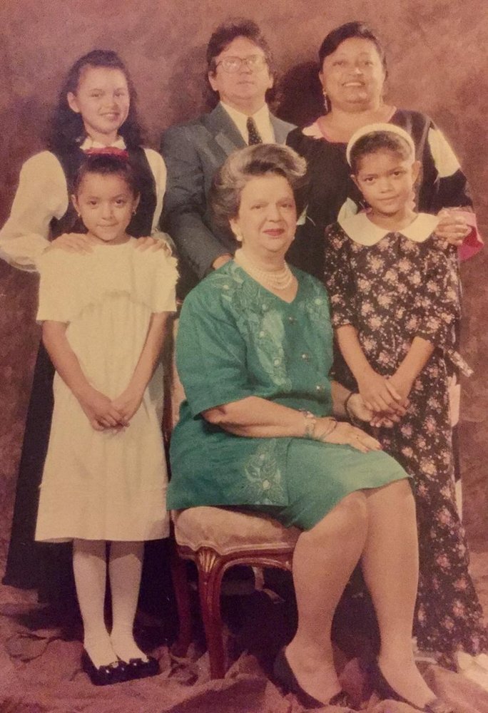 Old portrait-style photo of Paula as a young girl with her two sisters, mother, father and grandmother.