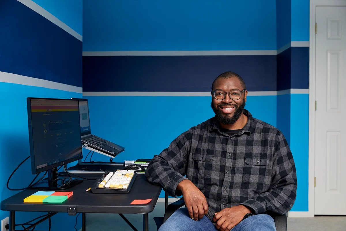 A UX Designer sitting in front of a double screened computer