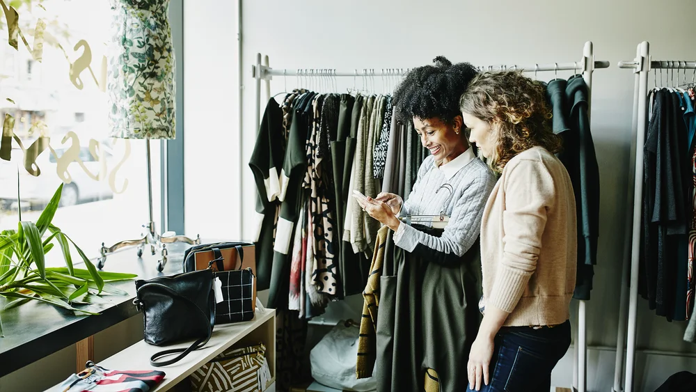 Building brand in Google: A photograph of two people shopping at a clothing store.