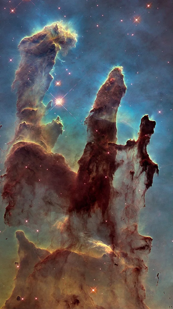 An image of Hubble’s “Pillars of Creation” – a colourful nebular with three distinct columns.