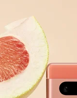 A photo showing the corner of a Coral Pixel 7a next to a grapefruit, showing the corresponding colors.