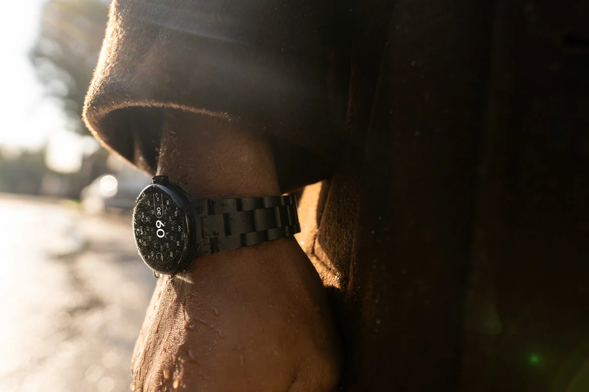 The Google Pixel Watch with Metal Links band in Matte Black is shown as a close-up view on a person’s wrist.