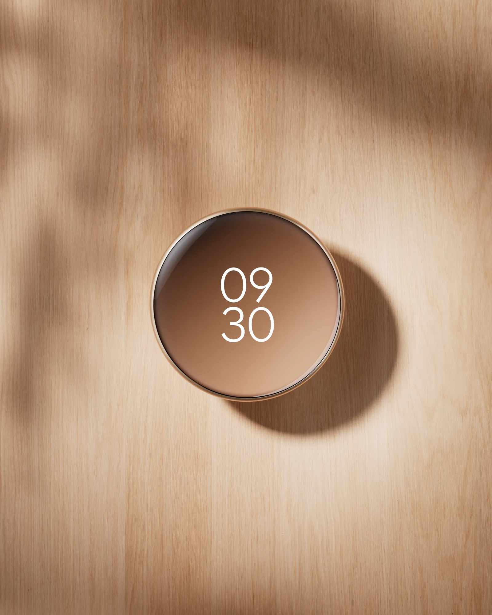 Polished Gold thermostat displayed on a wall