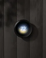 Polished Obsidian thermostat displayed on a wall in