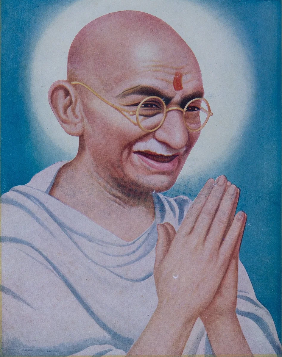 Illustration  of a bald man wearing gold wire rimmed glasses and white clothing with his palms pressed together in prayer position, against a blue background.