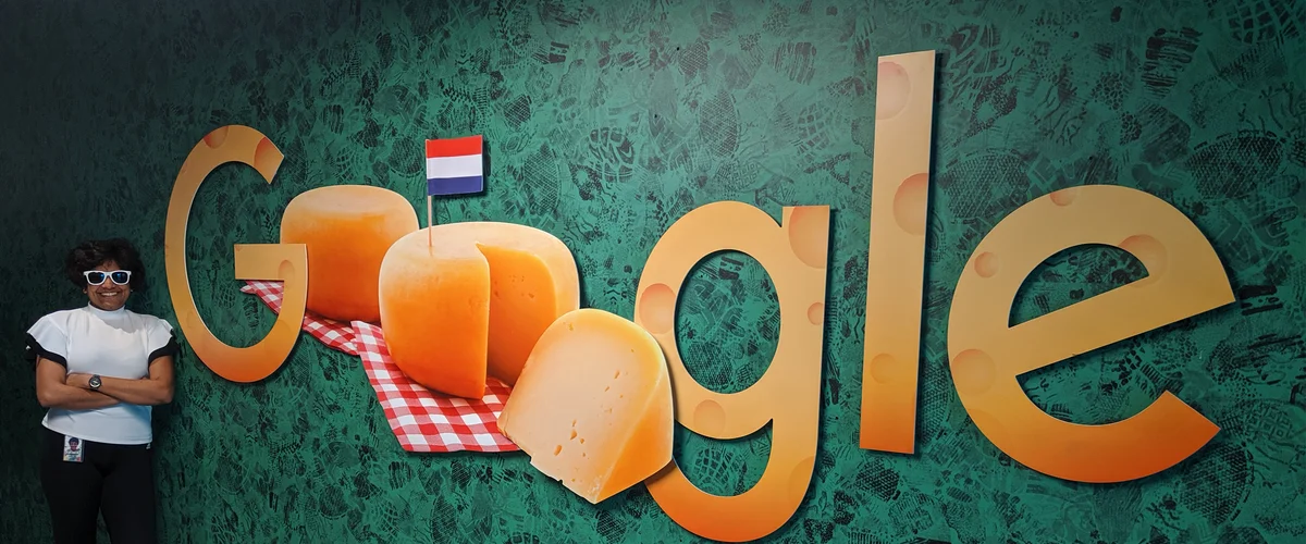 Priyanka stands by a cheese-themed Google logo at the Amsterdam office.