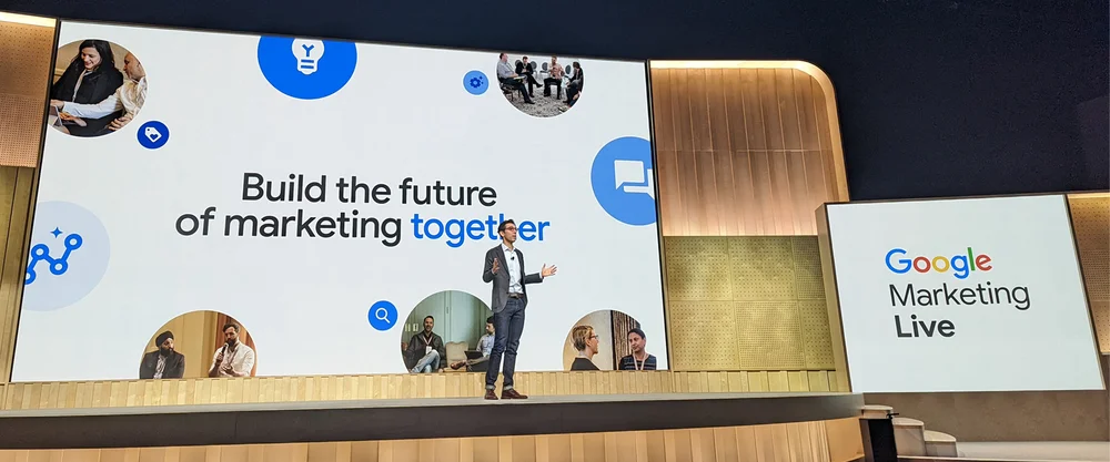 Photo of Jerry Dischler, Google Ads VP and GM, delivering the Google Marketing Live keynote in front of a screen that says “Build the future of marketing together”