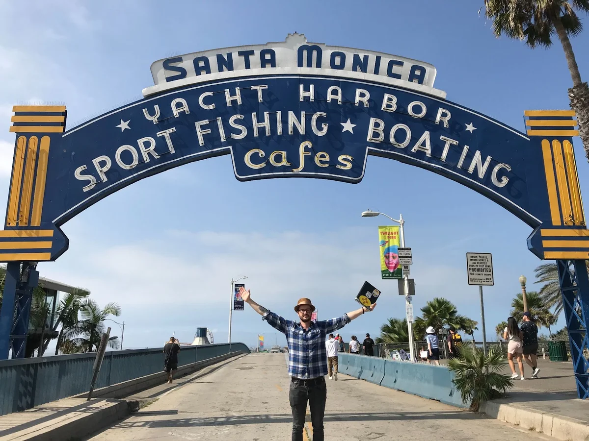 Photo of Matthew at the end of Route 66 in Santa Monica.