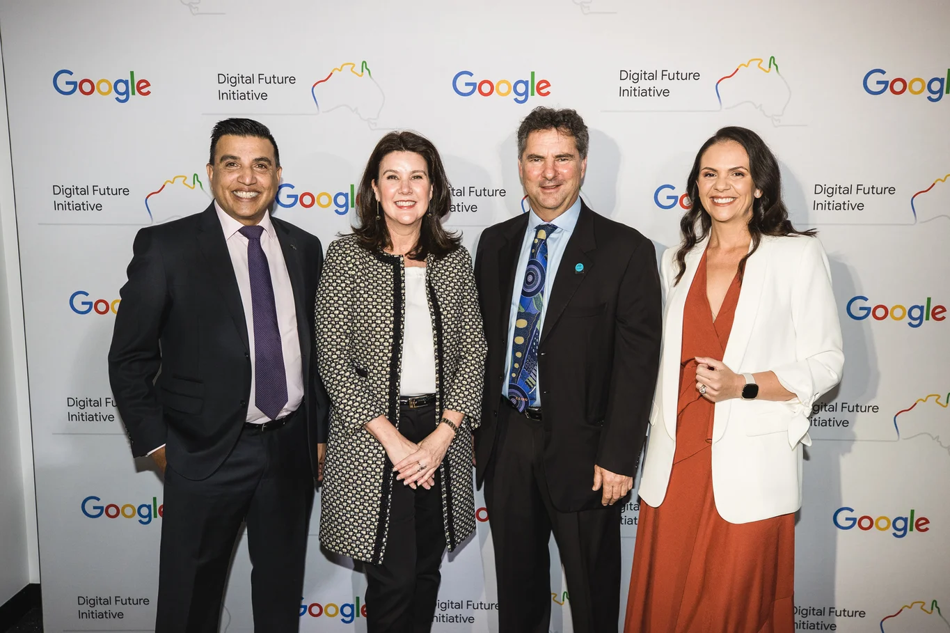 Alister Dias, Minister Jane Hume, Larry Marshall, and Mel Silva in front of a media wall