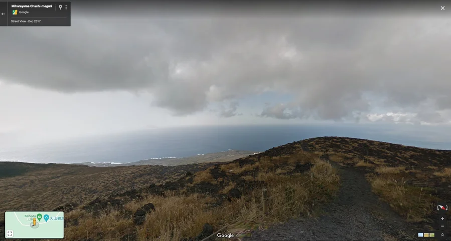 Street View image of a grassy hill overlooking the ocean