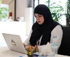 woman typing at a computer in an office