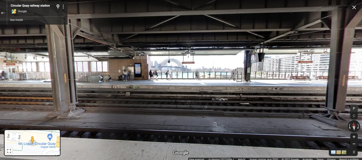 Street View imagery of the platform inside Circular Quay train station in Sydney, with a spectacular view of the Harbour Bridge.