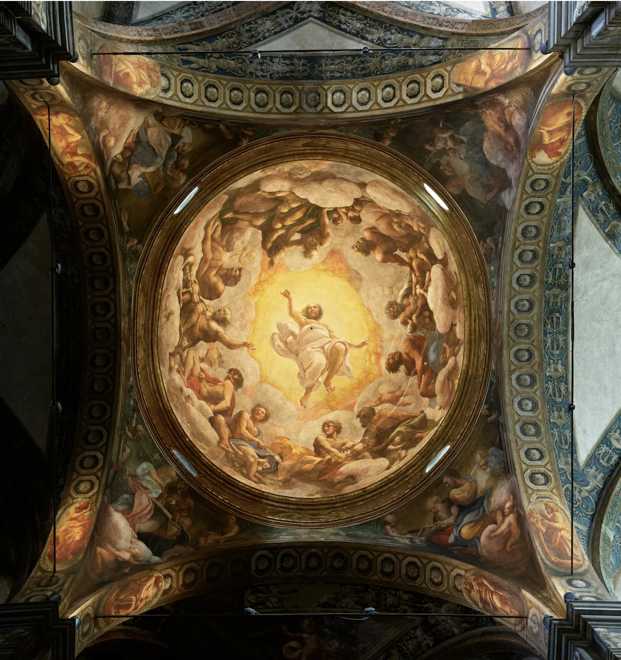 The image is a full view of the fresco that decorates the Church's dome. 27-metres-high, surrounded by a golden light, the Second Coming of Christ is portrayed, surrounded by the Apostles.