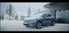 Video showing woman using remote actions to pre-warm her car before setting off on a drive in the snow.