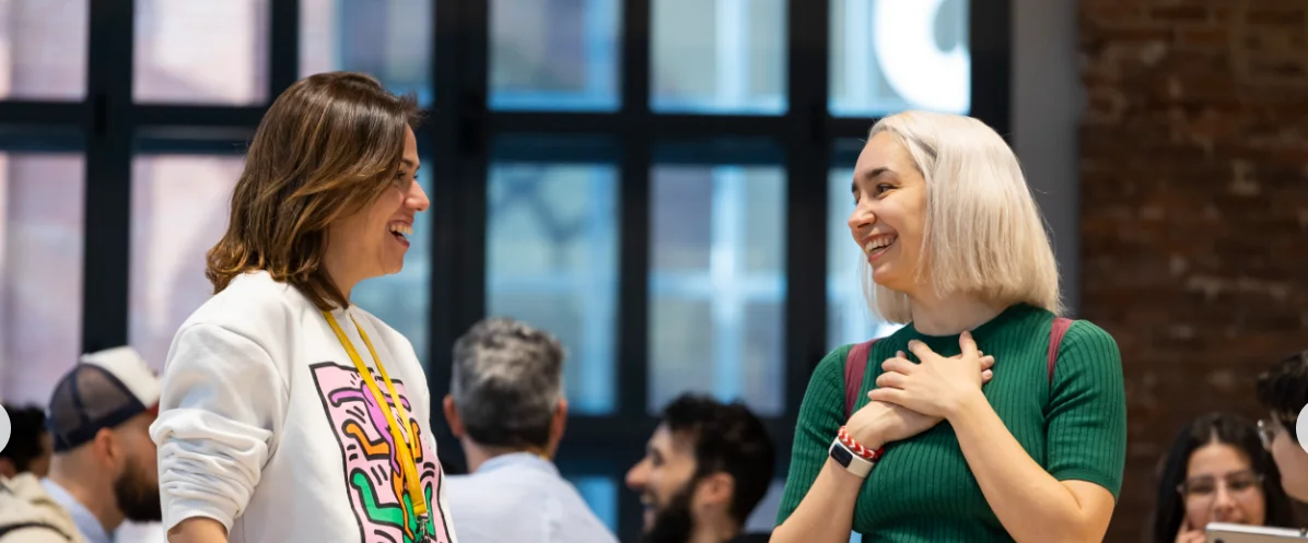 A photo of two female alumni talking