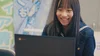 Photo of student smiling and looking at a Chromebook screen