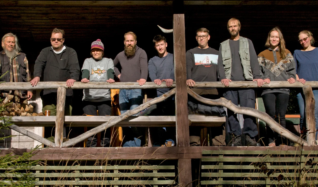 Team members from the Snowchange Cooperative standing near a bannister together.