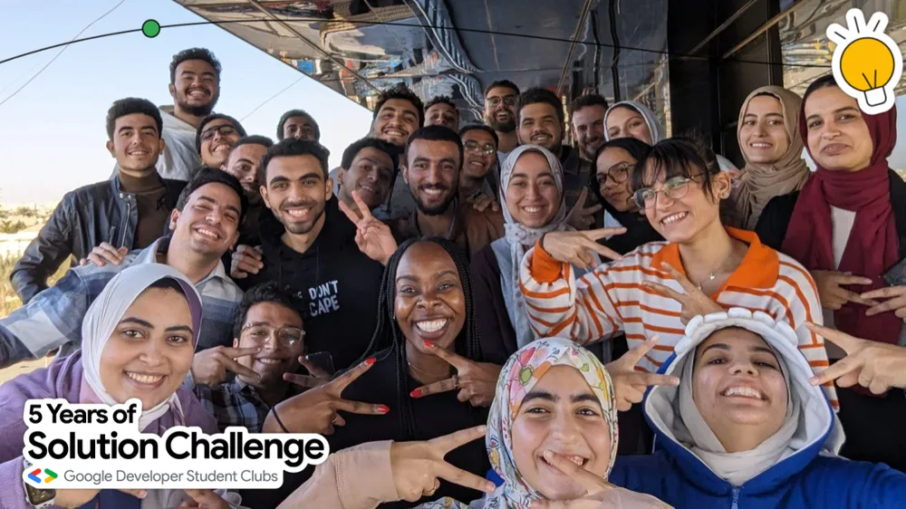 image of a group of people smiling with the phrase "5 years of solution challenge"