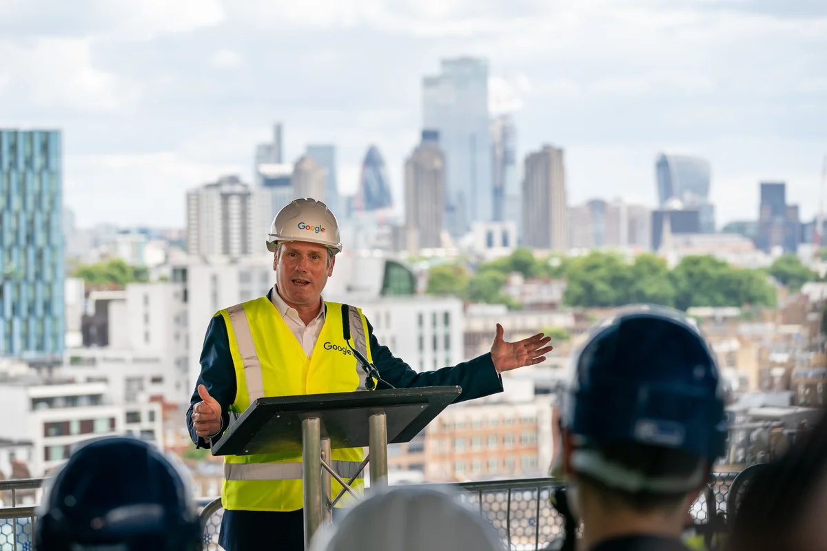 Keir Starmer with the London skyline behind him.