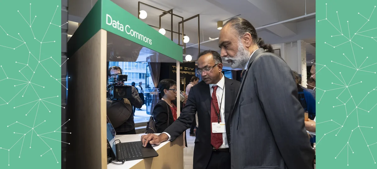 a picture of a person demonstrating technology to another person at a UN reception