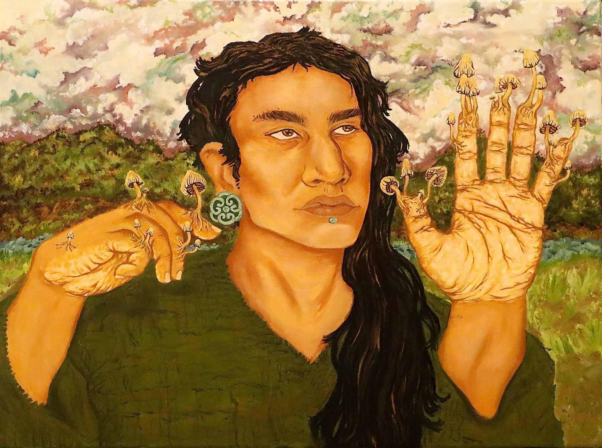 An oil painting of an indigenous man in 3/4 view holds his hands up, his fingers have begun to sprout mushrooms and the clouds gather behind him above the forest. He has long black hair, which he wears on the side and wears an olive green, v-neck top. He wears a teal earring on his left ear as well as a stud under his lip.