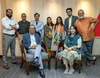 A group of people in a room smiling for the camera