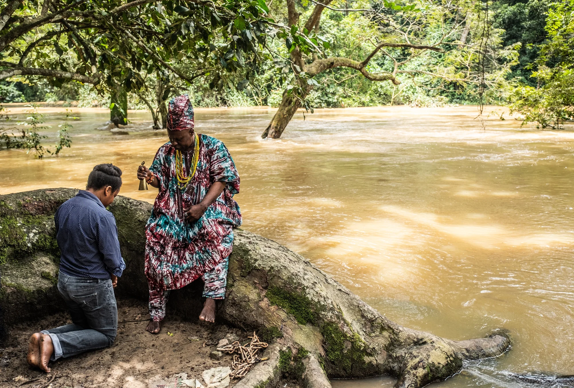 Image showing the priest of Osun on the banks of a river performing a blessing for Jumoke Sanwo