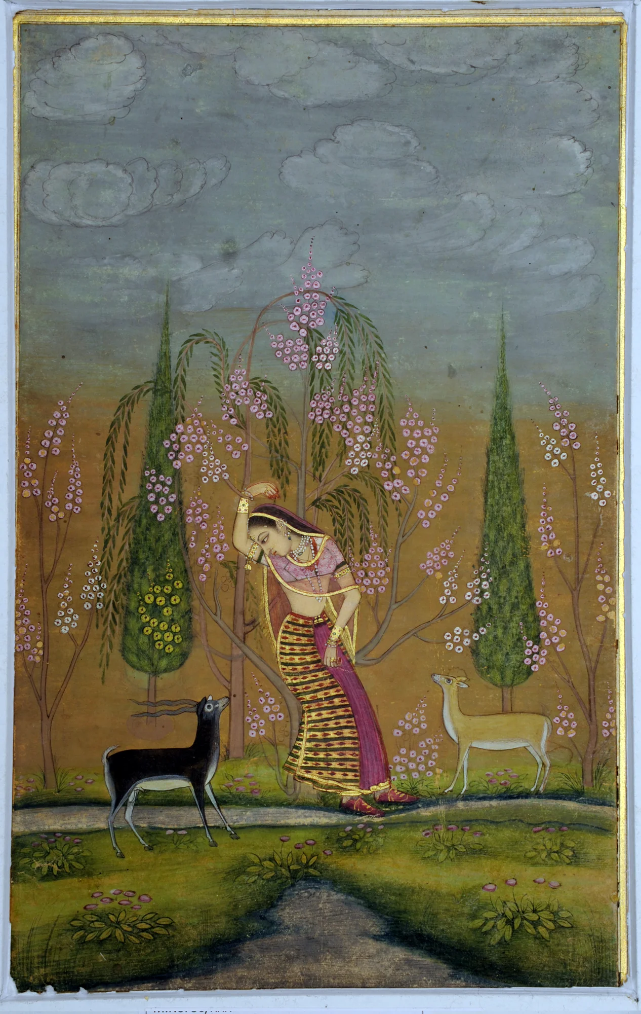 Indian miniature painting of a woman standing under trees, accompanied by two animals