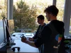 Tomas and teammate standing at a desk.