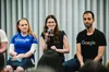 Avital speaking into a microphone while sitting with other Googlers.