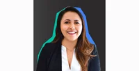 Image shows a headshot of a woman with long brown hair and a black blazer smiling at the camera against a black background.