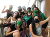 This is a photo of women posing together wearing masks.