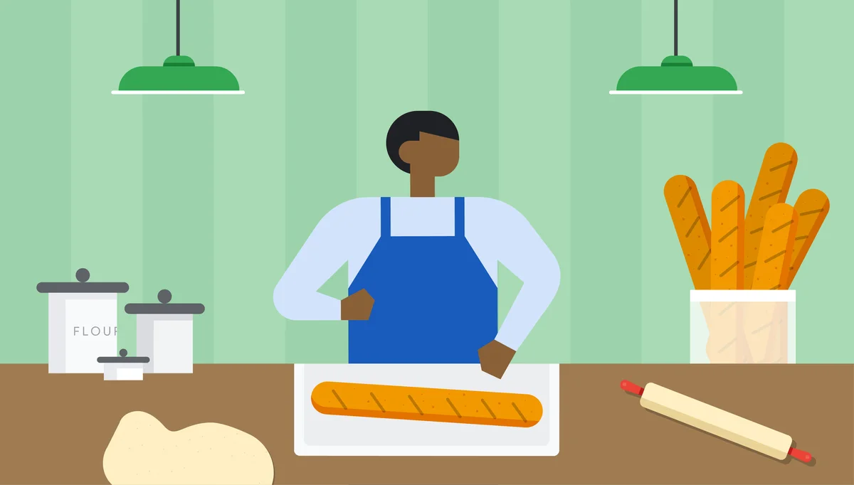 An illustration of a person in a blue apron standing behind a table and in front of a green wall. The table has jars of flour, a rolling pin, some dough and a loaf of baked bread sitting on a cutting board.