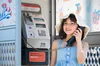 Young girl at a Telstra payphone