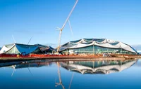 A photo of Bay View campus under construction, including two unique shaped buildings and a crane.