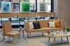 A couch, chair and coffee table stand in front of the Discovery Boxes inside Google’s retail store.