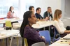 An attendee of an event co-hosted by NGLCC and Google, sitting in a yellow chair looking forward