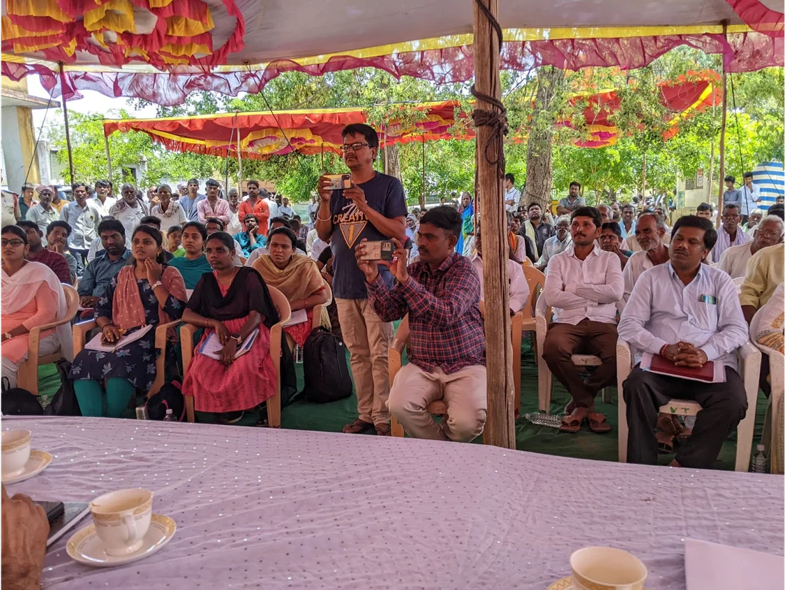 a crowd of people in discussion