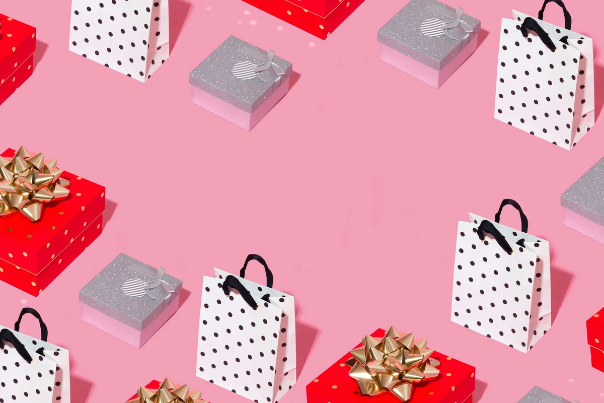 A collage of wrapped gifts and shopping bags against a pink background.