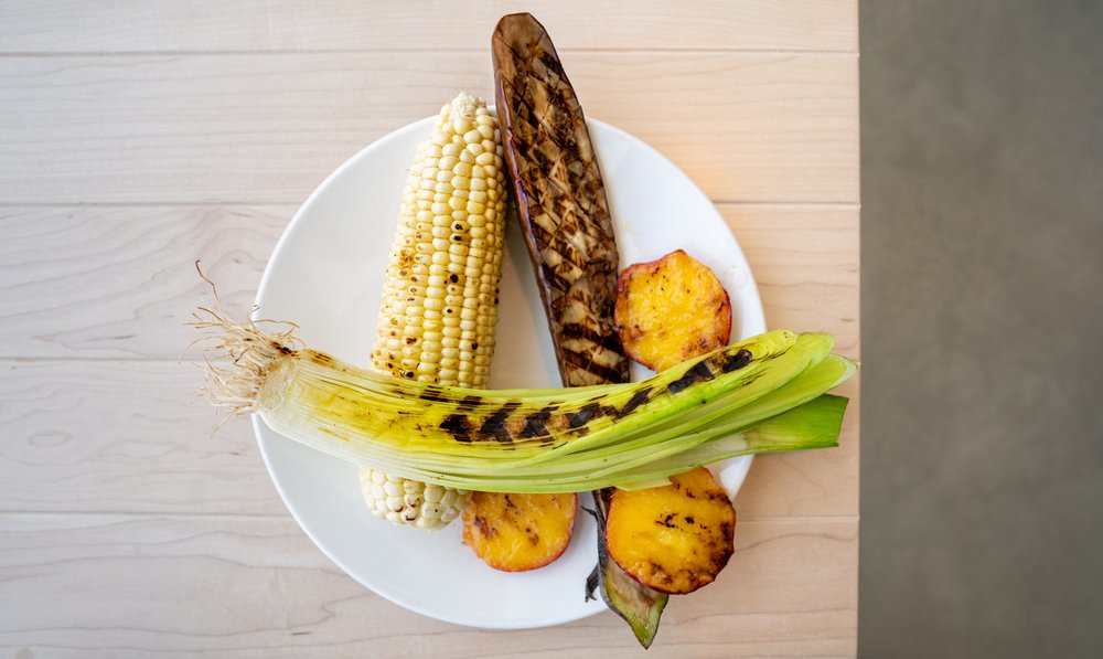 A plate of vegetables is arranged to showcase grill marks.