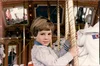 Photo of author riding a merry-go-round.