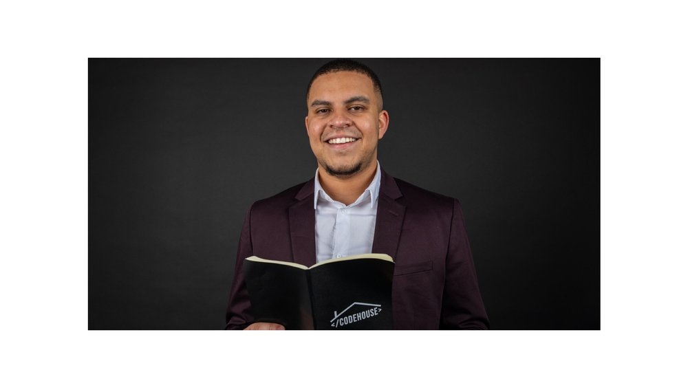 Image showing a man in a suit holding a book that says