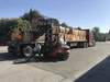 A fork lift loads stacks of wood doors onto the back of a truck to get ready for donation.